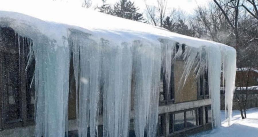 ice dam removal of large icicles on roof in grand rapids michigan